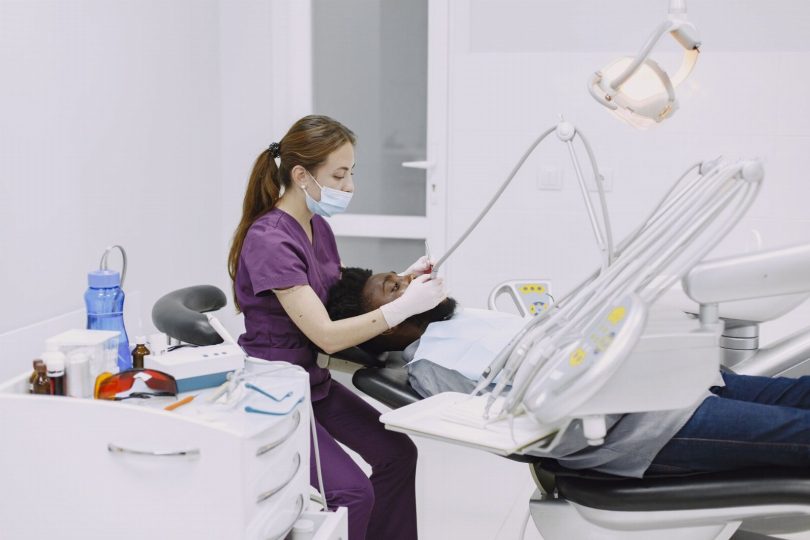 Recepção de clínica odontológica perto do metrô Paraíso com paciente e dentista